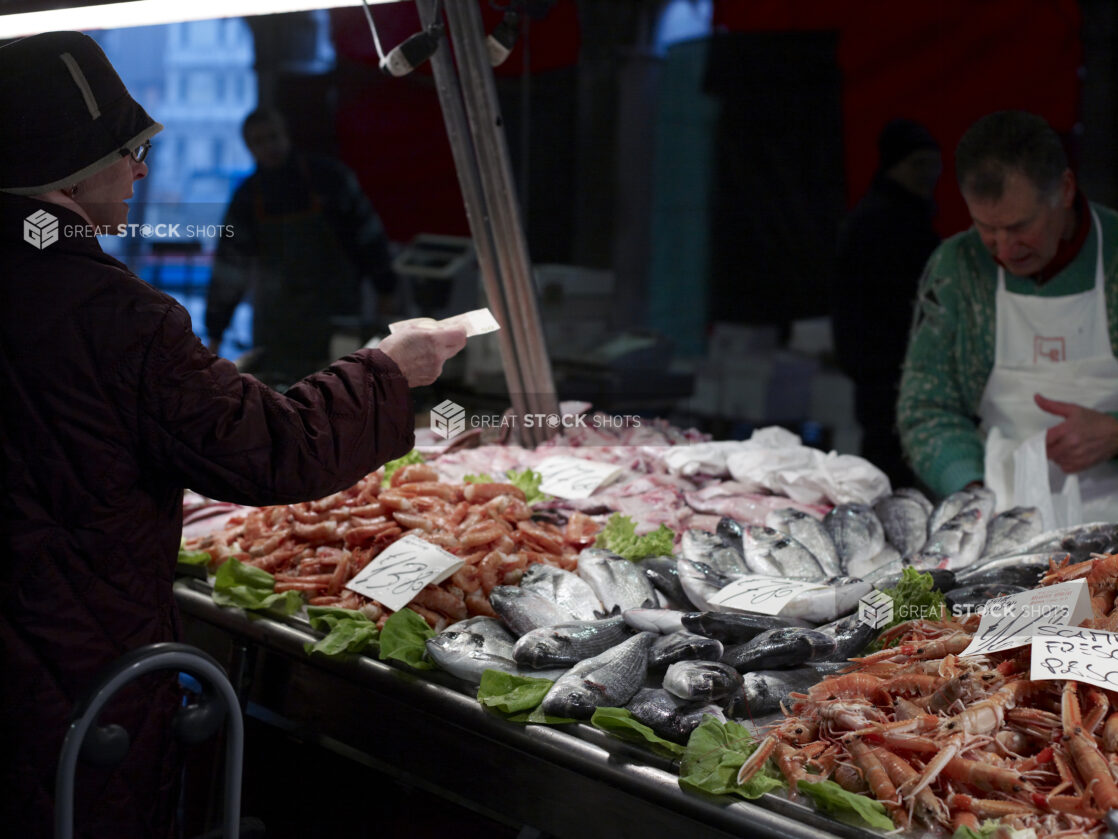 A Customer Buying Seafood at a Stall in a Food Market in Venice, Italy