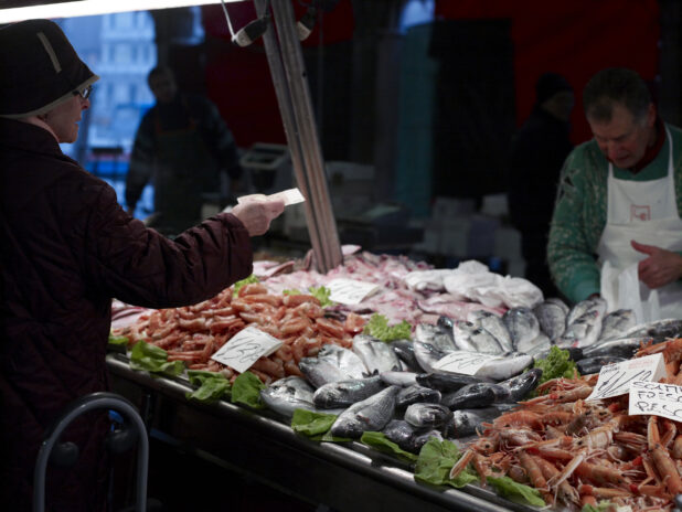 A Customer Buying Seafood at a Stall in a Food Market in Venice, Italy