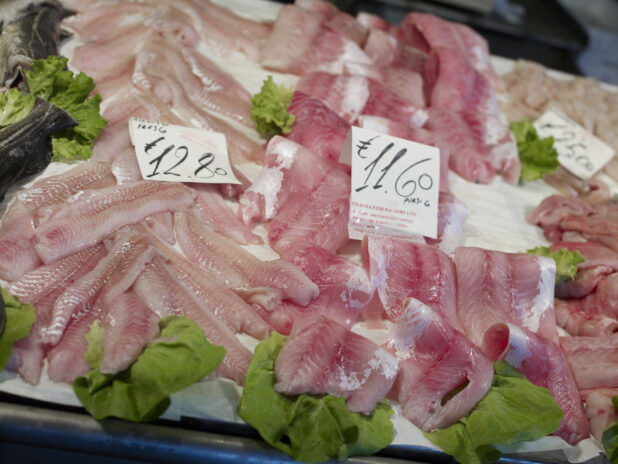 Assorted Cuts of Fresh Fish Fillets at a Seafood Stall in a Food Market in Venice, Italy