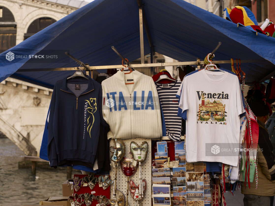 An Outdoor Souvenir Kiosk Selling Clothing, Postcards and Venetian Masks in Venice, Italy