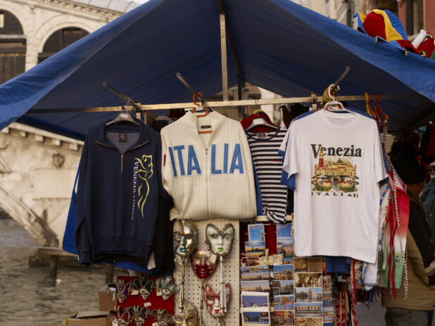 An Outdoor Souvenir Kiosk Selling Clothing, Postcards and Venetian Masks in Venice, Italy