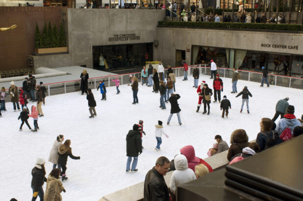 People Skating on the Outdoor Ice Rink in the Lower Plaza of the Rockefeller Center during Winter in Manhattan, New York City