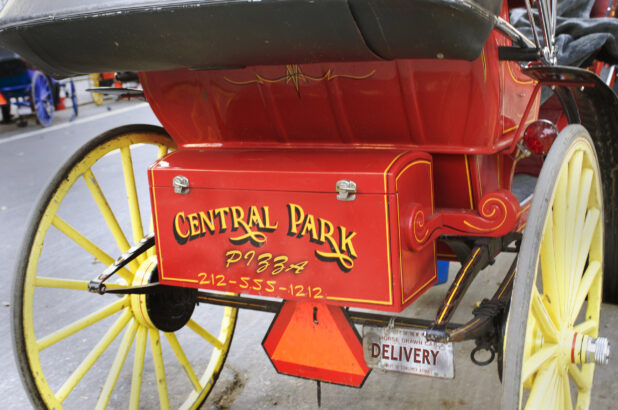 Close-Up of an Advertisement on the Rear Trunk of a Horse-Drawn Carriage in Manhattan, New York City