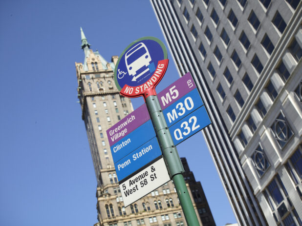 Greenwich Village M5 Bus Stop Sign with the Sherry-Netherland Hotel Tower in the Background in Manhattan, New York City