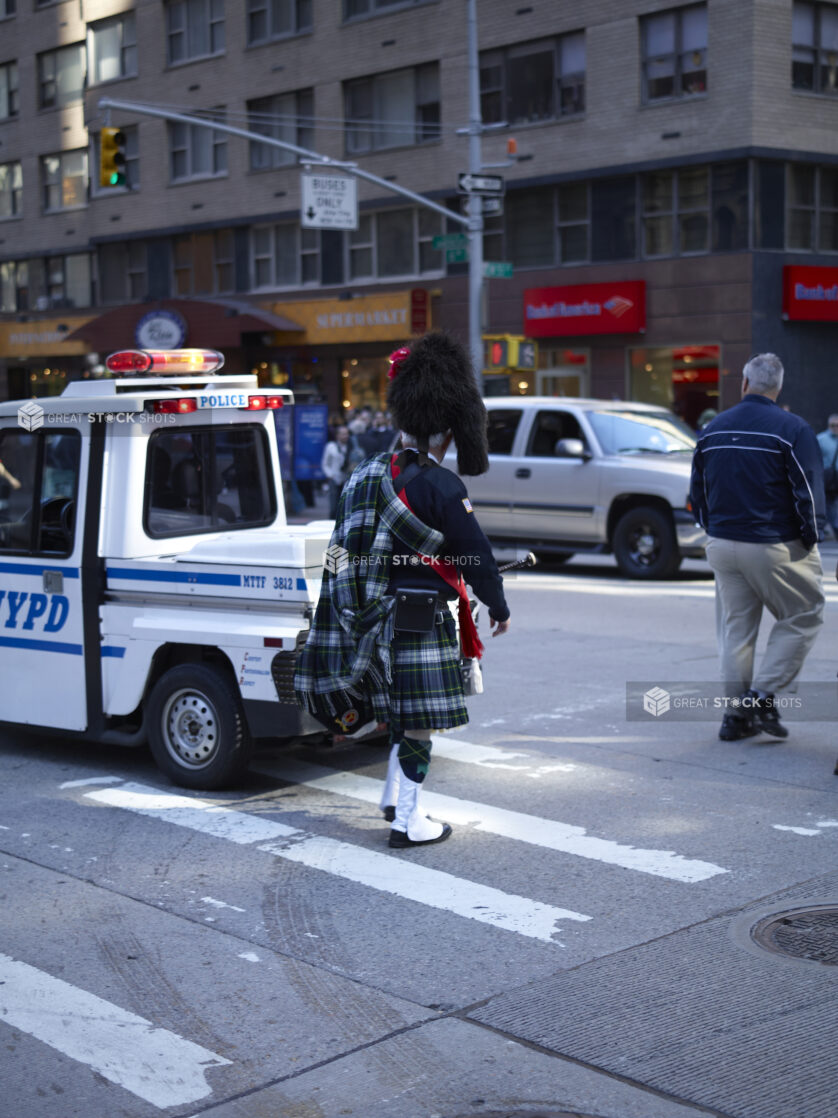 Man Wearing Full Traditional Scottish Kilt Crossing a Street on Tartan Day Parade in Manhattan, New York City