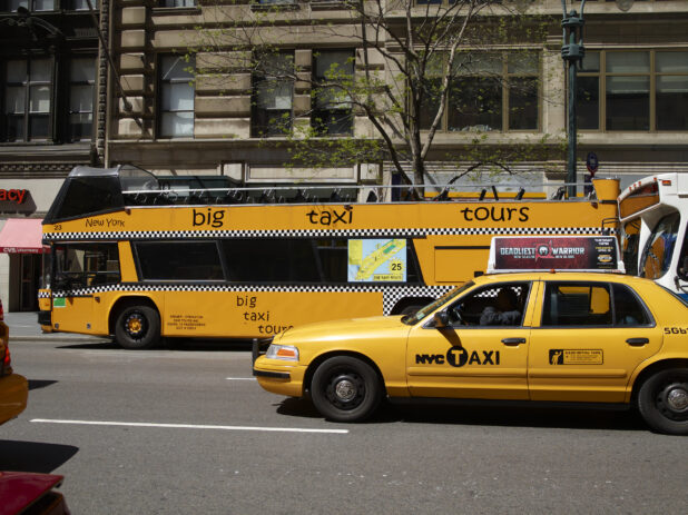 A Yellow NYC Taxi Cab Beside a Yellow Double Decker Sightseeing Tour Bus in Manhattan, New York City