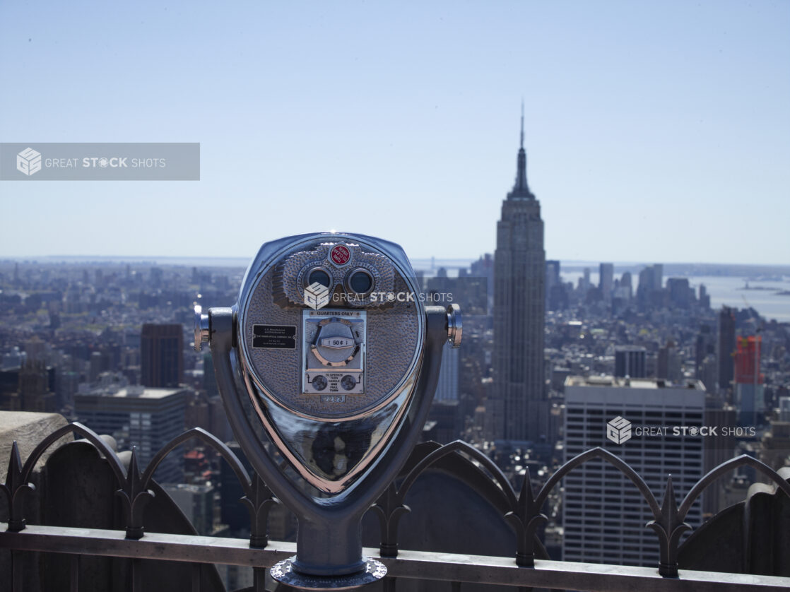 Coin-Operated Binoculars on the Viewing Platform at the Top of Rockefeller Center with the Empire State Building in the Background in New York City