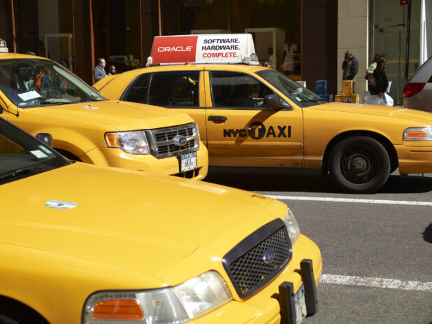 Close Up of Yellow Taxi Cabs Lined Up on a Busy New York City Street