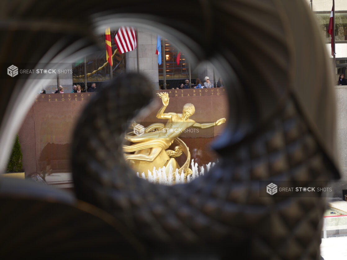 View of the Prometheus Sculpture Through Another Sculpture in the Rockefeller Center in Manhattan, New York City