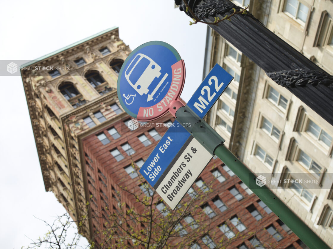 Lower East Side M22 Bus Stop Sign with the Broadway Chambers Building in the Background in Manhattan, New York City