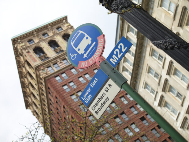 Lower East Side M22 Bus Stop Sign with the Broadway Chambers Building in the Background in Manhattan, New York City