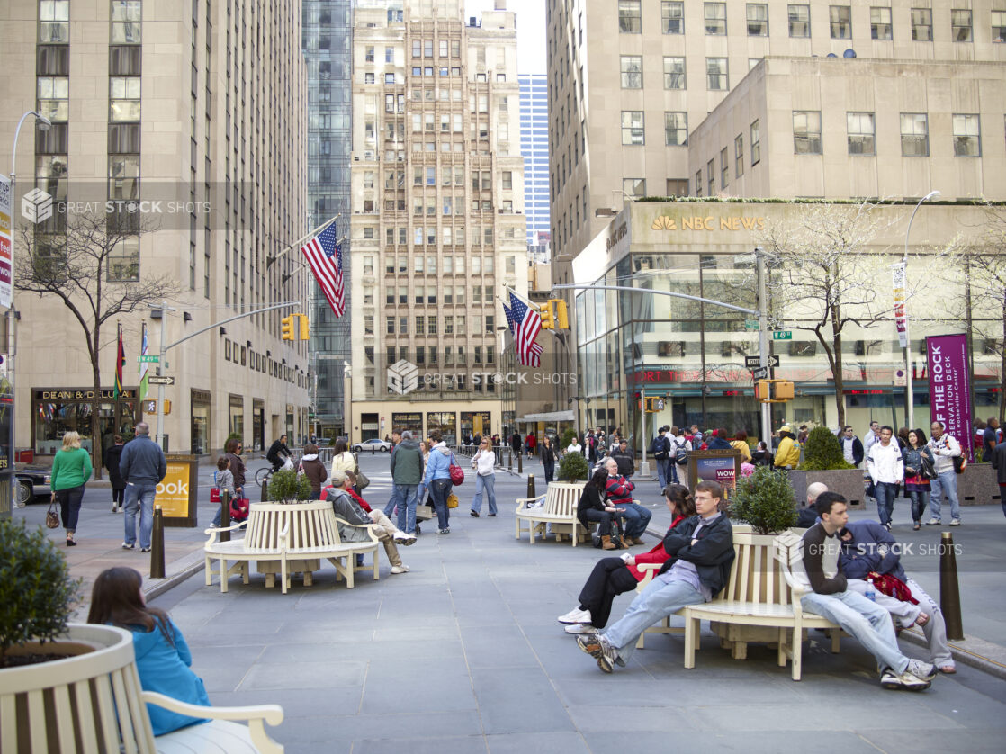City Park with People Sitting on Benches across from Rockefeller Plaza and NBC News Studio in Manhattan, New York City