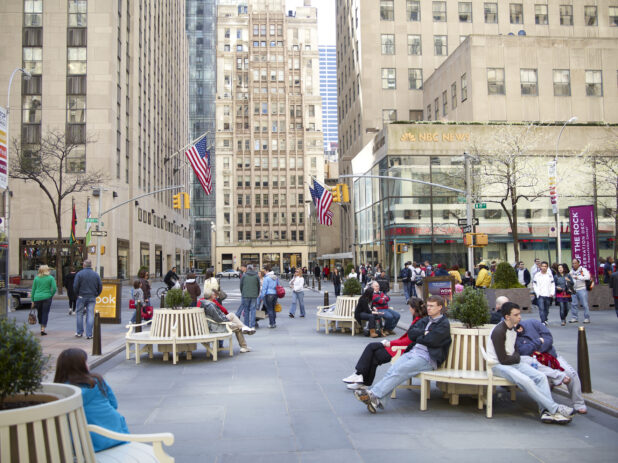 City Park with People Sitting on Benches across from Rockefeller Plaza and NBC News Studio in Manhattan, New York City