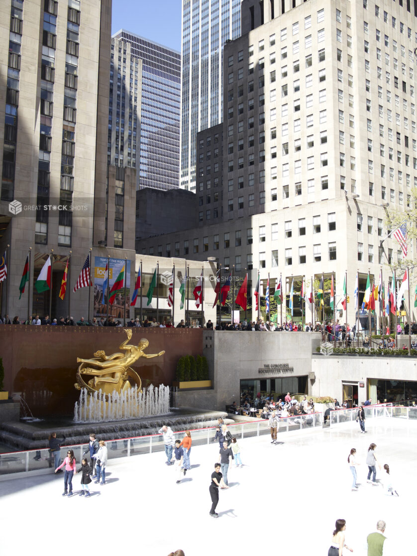 People Skating on the Outdoor Ice Rink in Front of the Prometheus Sculpture in the Lower Plaza of the Rockefeller Center in Manhattan, New York City