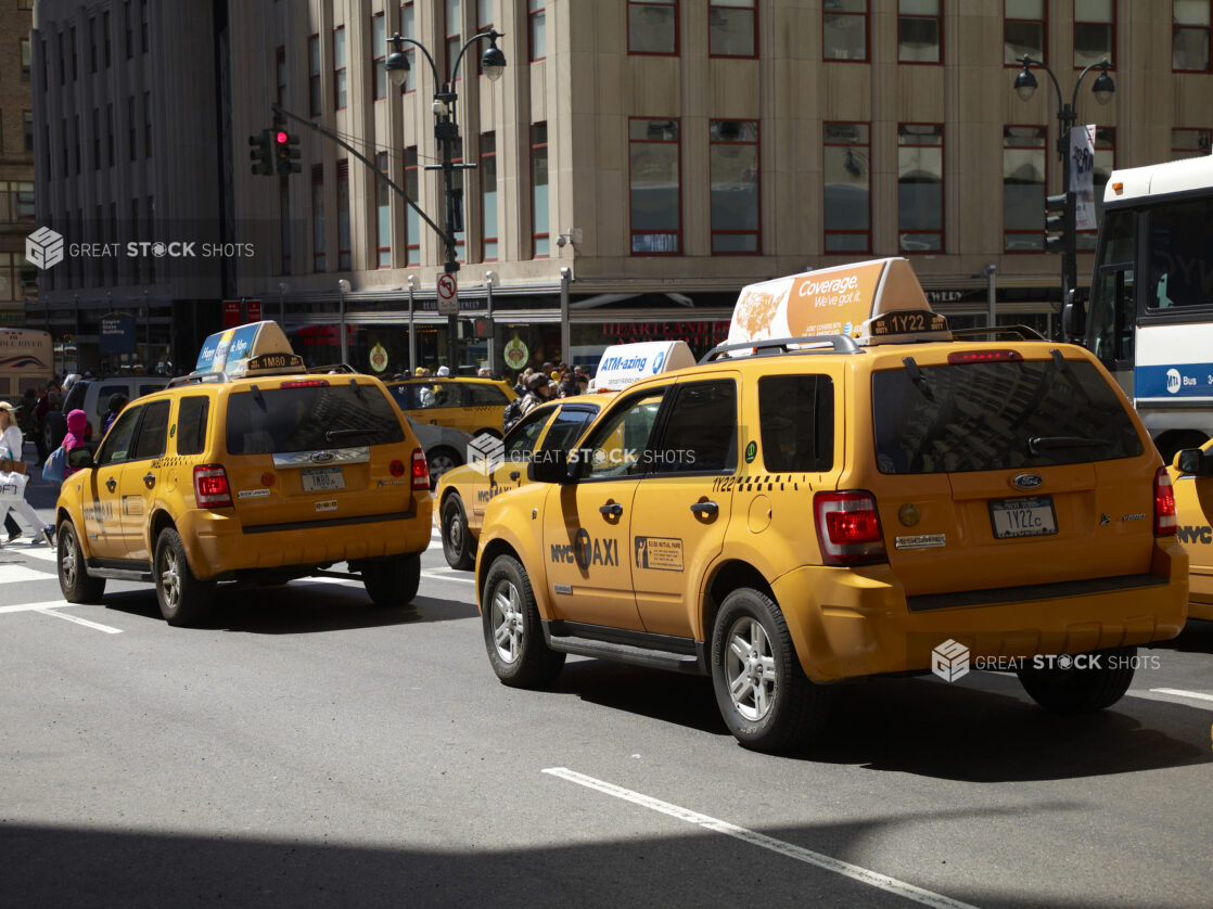 Rear View of Yellow NYC Taxi Cabs Waiting at an Intersection in Manhattan, New York City