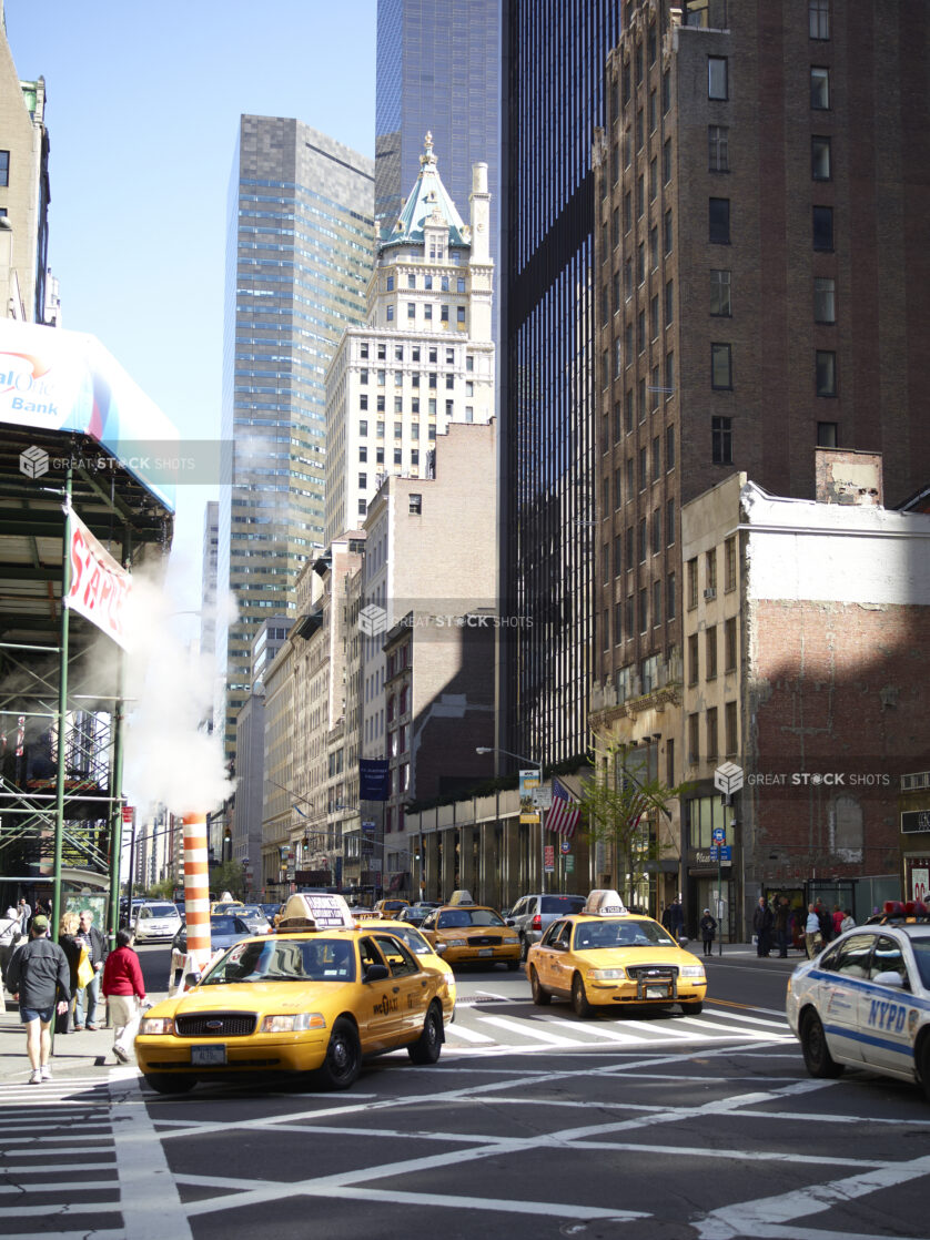 Sixth Avenue with Yellow NYC Taxicabs and the Crown Building in Manhattan, New York City
