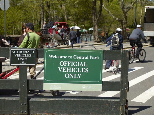 Vehicle Restriction Signage on a Wooden Gate in Front of Central Park in Manhattan, New York City