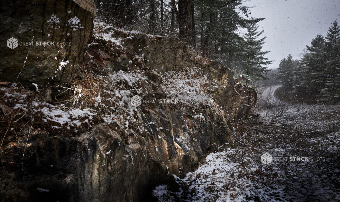 Snow Falling on Rock Formations Along a Road in Cottage Country in Ontario, Canada