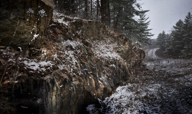 Snow Falling on Rock Formations Along a Road in Cottage Country in Ontario, Canada