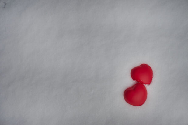Two Bright Red Hearts Embedded in Fresh, Pristine Snow for Valentine's Day