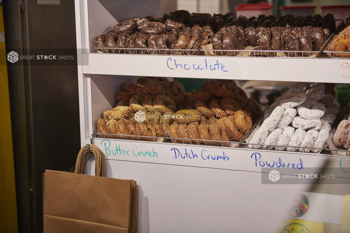 Racks of Assorted Handmade Donuts in a Donut Shop in an Indoor Market