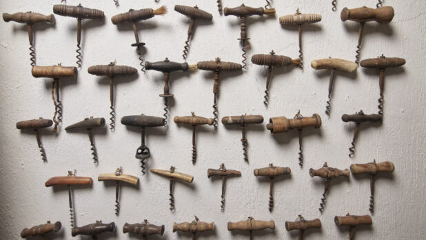 Antique Corkscrews and Wine Bottle Openers Alined on a Wall in the Wine Museum of Ristorante Pagnanelli in Castel Gandolfo, Italy - Variation