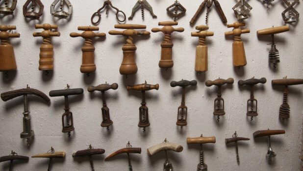 Antique Corkscrews and Wine Bottle Openers Alined on a Wall in the Wine Museum of Ristorante Pagnanelli in Castel Gandolfo, Italy