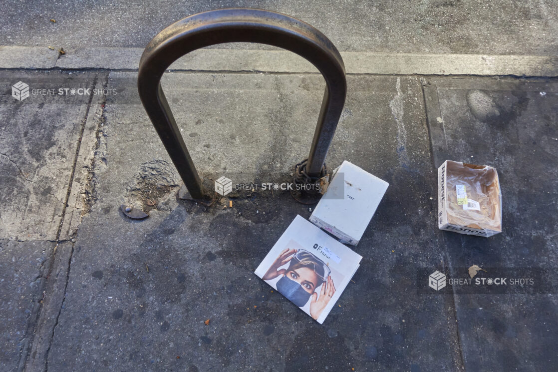 View of a Bike Rack and Sidewalk Littered with Cardboard Boxes During Lockdown in New York City