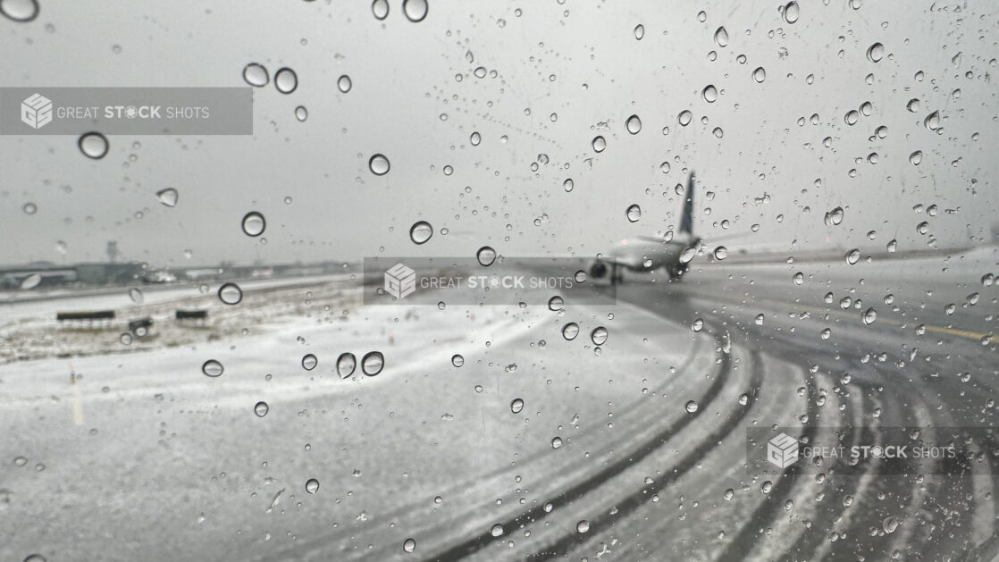 View From a Window Out to an Airport Runway During Bad Winter Weather