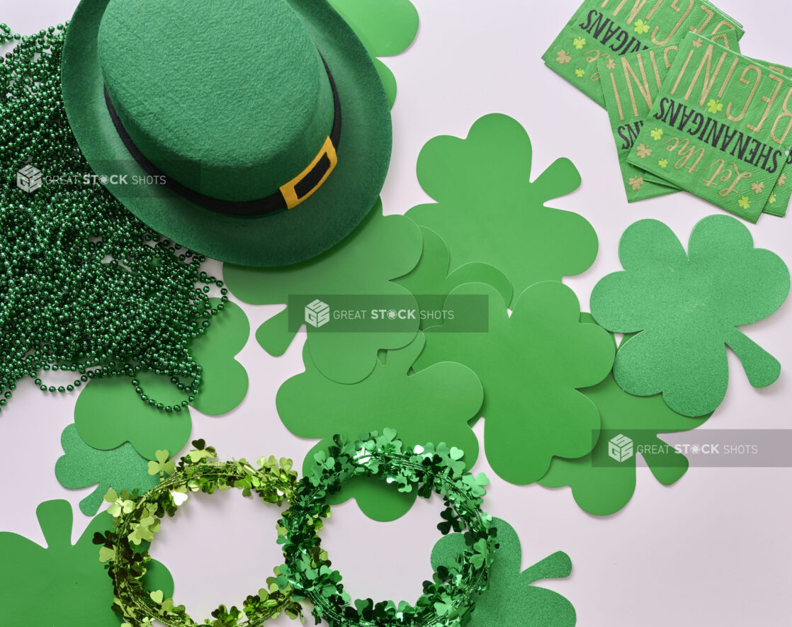 Overhead View of an Assortment of St. Patrick’s Day Decorations – Shamrock Wreaths, Leprechaun Hat, Green Clover Clings and Green Paper Napkins