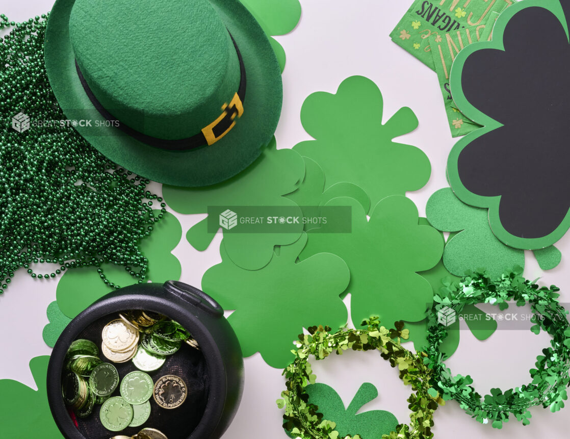 Overhead View of an Assortment of St. Patrick's Day Decorations - Shamrock Wreaths, Leprechaun Hat, Green Clover Clings and a Pot of Gold