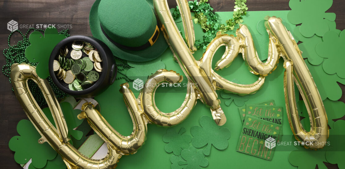 Overhead View of a Gold “Lucky” Balloon Surrounded by St. Patrick’s Day Decorations on a Dark Wood Surface – Variation 2