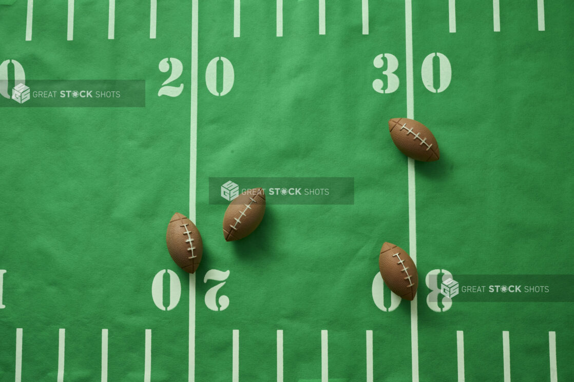 Overhead View of an American Football Field Table Cloth with Football Shaped Erasers Scattered About