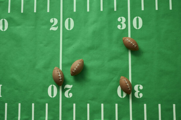 Overhead View of an American Football Field Table Cloth with Football Shaped Erasers Scattered About