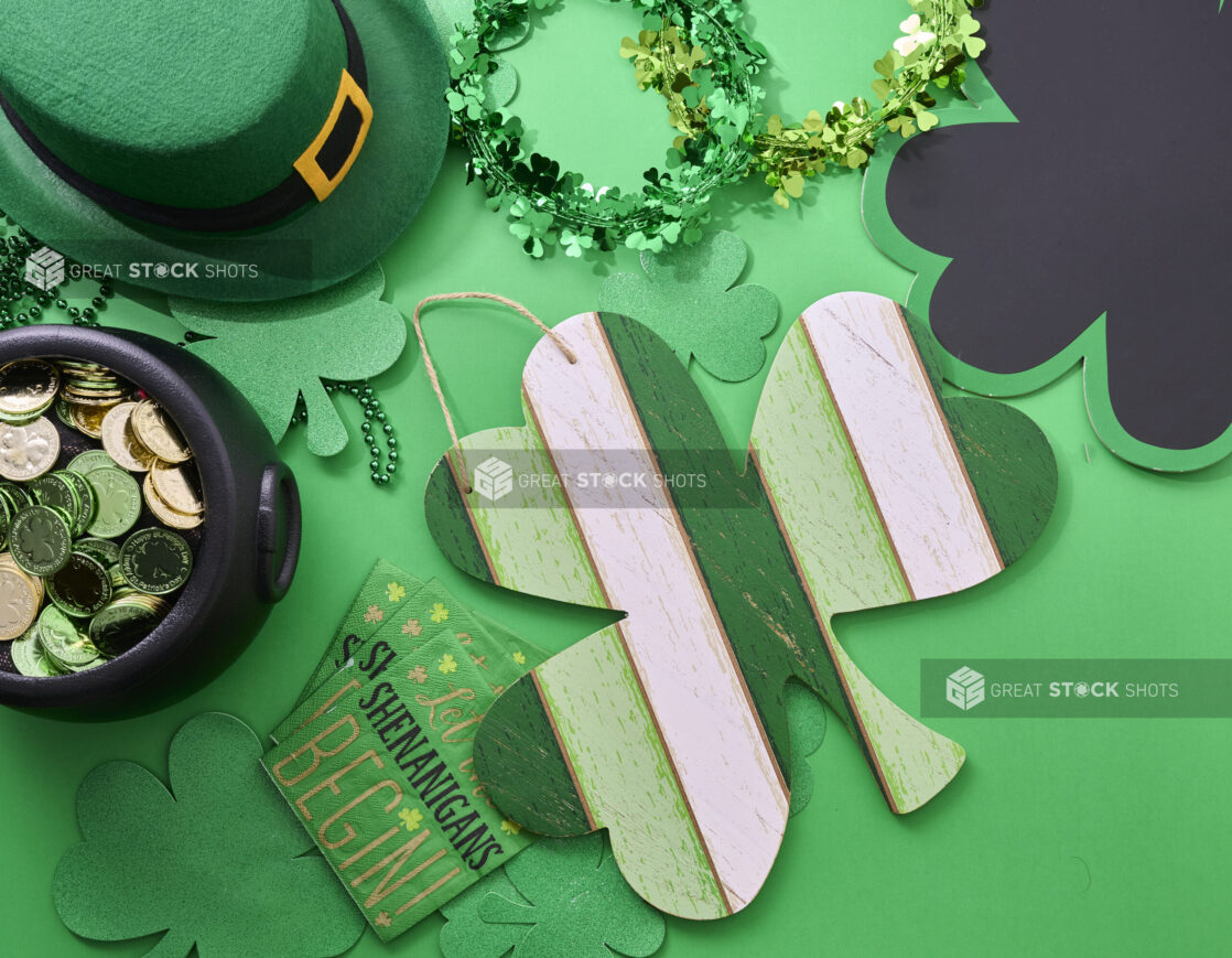 Overhead View of a Painted Wood Shamrock Sign Surrounded by St. Patrick’s Day Decorations on a Green Background - Variation